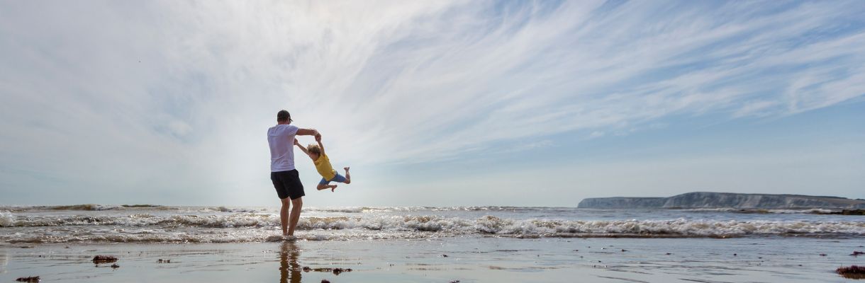 Father and son playing on Compton beach, Isle of Wight